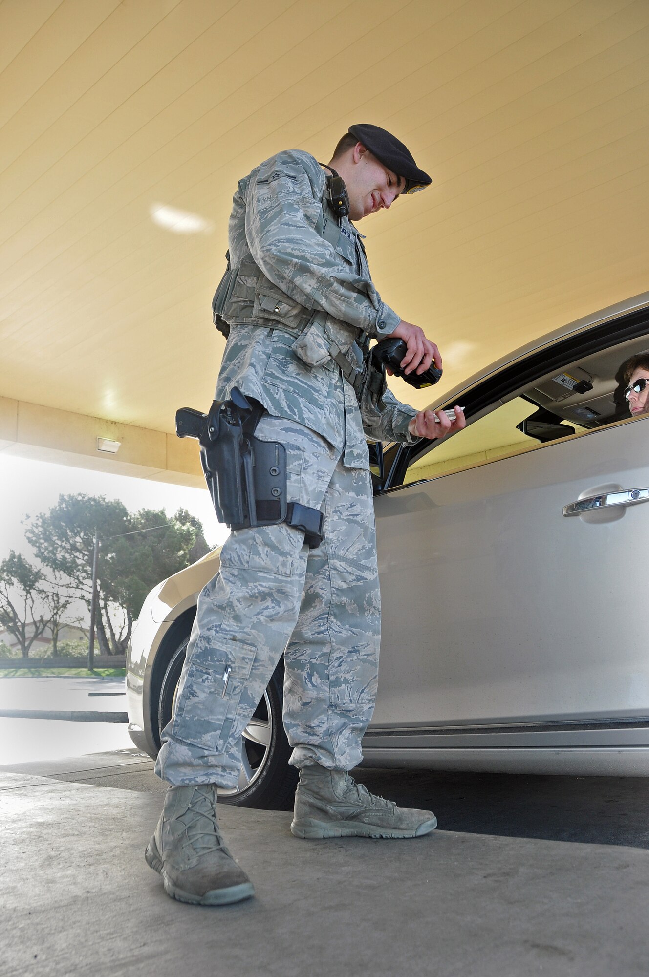 Airman Zachary Buonacorsi, 60th Security Forces Squadron, uses a scanner to verify a government identification card through the Defense Biometric Identification System March 6 at the main gate on Travis. (U.S. Air Force photo/Senior Airman Madelyn Brown)