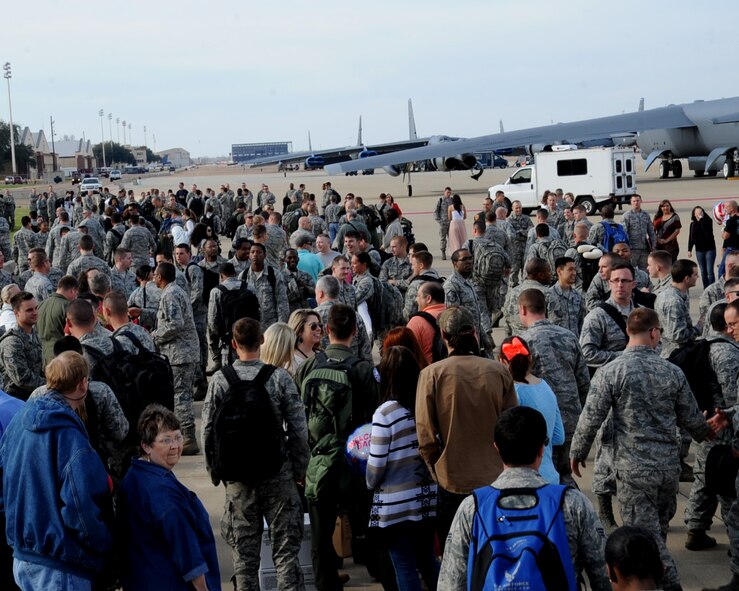 Airmen rejoice with their friends and family after returning from Andersen Air Force Base, Guam, on Barksdale Air Force Base, March 7, 2014. The Airmen were on a six month deployment in support of the Continuous Bomber Presence. (U.S. Air Force photo/Staff Sgt. Sean Martin)