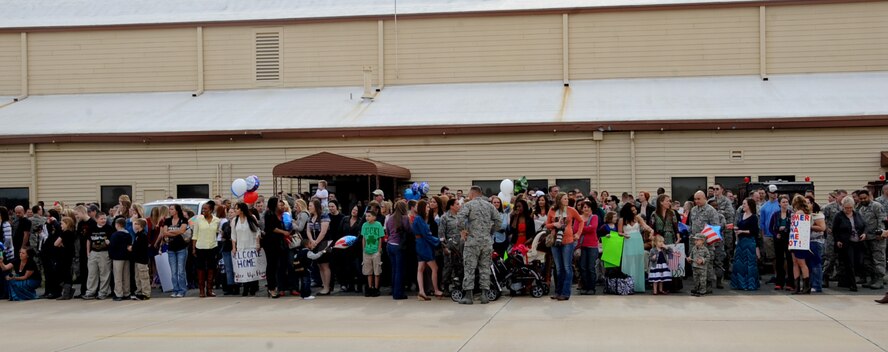 Team Barksdale families and coworkers wait for Airmen to arrive on Barksdale Air Force Base, March 7, 2014. The Airmen were returning from Andersen Air Force Base, Guam, after a six month deployment in support of the Continuous Bomber Presence. (U.S. Air Force photo/Staff Sgt. Sean Martin)