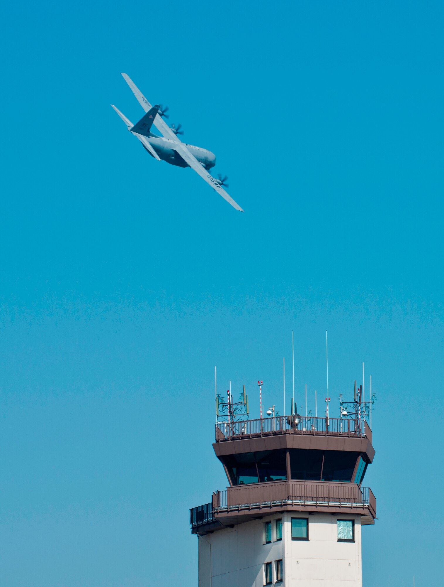 A C-130J Super Hercules flies over an air traffic control facility March 14, 2014, Ramstein Air Base, Germany. In one year more than 25,000 aircraft have gone through Ramstein. (U.S. Air Force photo/Senior Airman Jonathan Stefanko)
