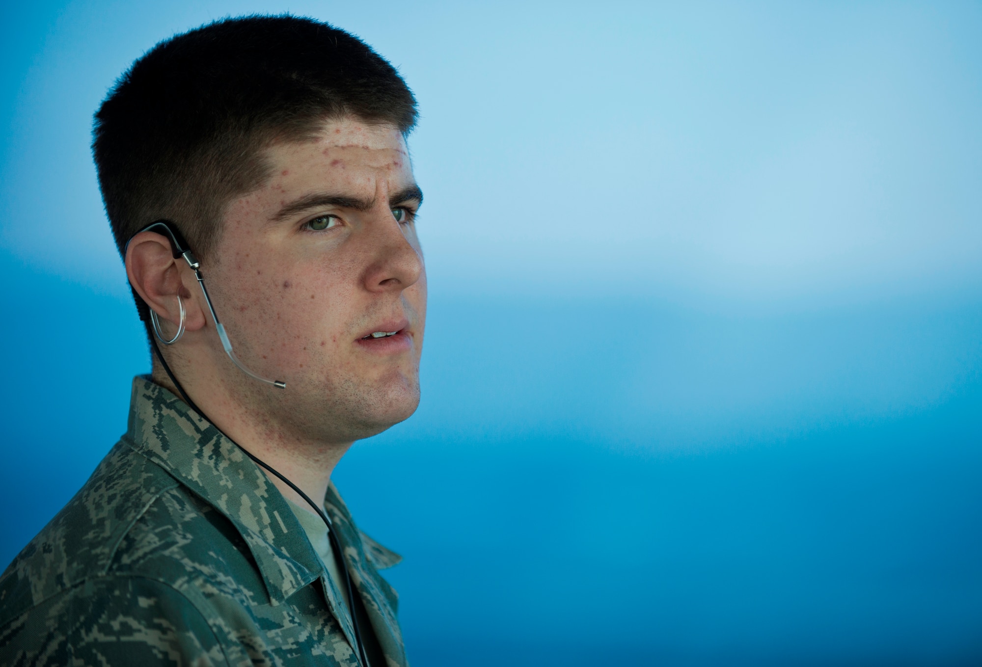 Airman 1st Class Matthew Rogers, 86th Operations Support Squadron air traffic controller, talks to a pilot through his microphone March 14, 2014, Ramstein Air Base, Germany. Air traffic controllers at Ramstein Air Base are responsible for providing safe and efficient air traffic flow by policing the movement of aircraft, issuing safety alerts and giving pilots a clear and precise picture of what is in the air space around them. (U.S. Air Force photo/Senior Airman Jonathan Stefanko)