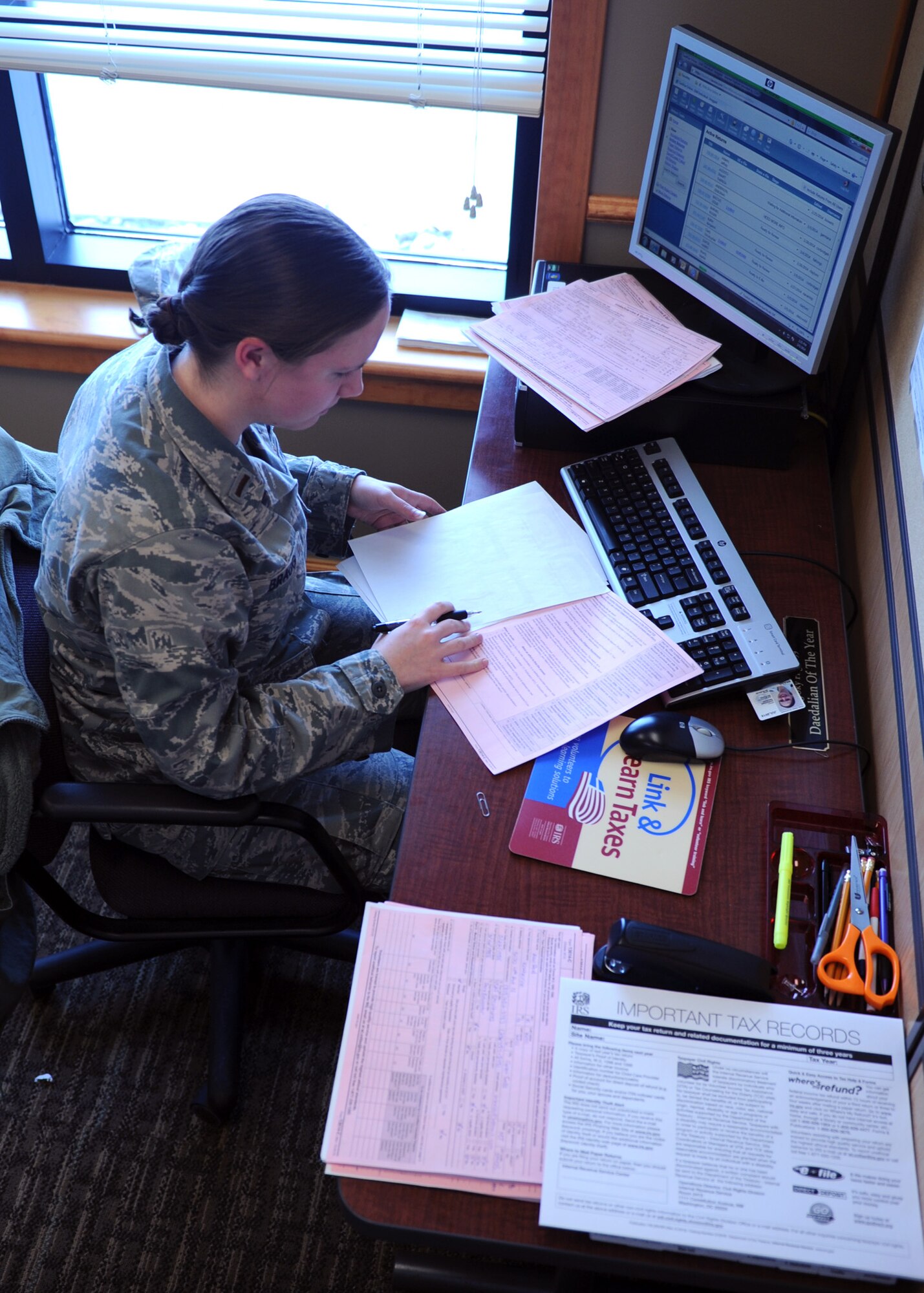 2nd Lt. Amy Bragg, 341st Comptroller Squadron deputy budget officer, provides a quality review on a tax return filed by another volunteer before sending it to the Internal Revenue Service. Six Malmstrom Airmen volunteer their time offering free tax returns at the Malmstrom Air Force Base Tax Center located at the Grizzly Bend. (U.S. Air Force photo/Senior Airman Katrina Heikkinen)