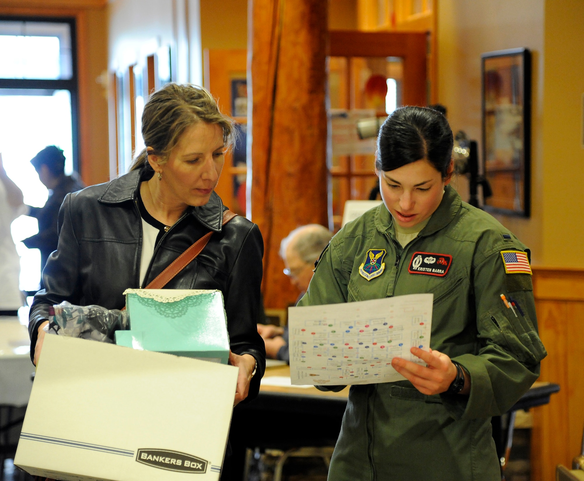 1st Lt. Kristen Barra, 12th Missile Squadron combat crew commander (right), assists a local community member with finding her display table location during Malmstrom’s 2014 Community Fair on March 7 at the Grizzly Bend. According to volunteers, the fair was a success and helped strengthen Malmstrom’s relationship with the community. (U.S. Air Force photo/Airman 1st Class Collin Schmidt)  