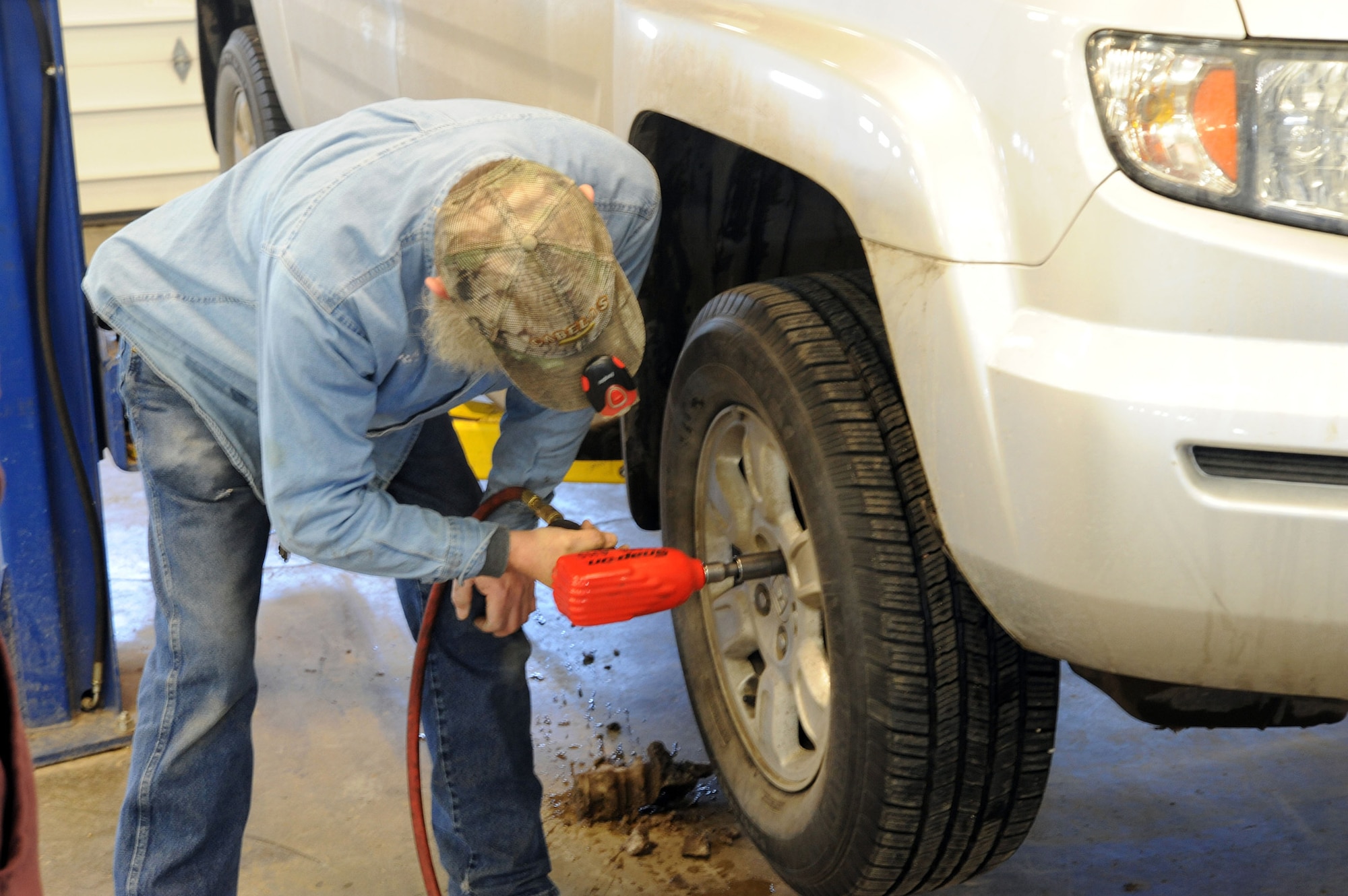 Roy Ranum, Malmstrom Auto Hobby Shop mechanic, loosens up lug nuts on a truck for a customer at the base auto hobby shop March 7. The auto shop offers customers a chance to “rent a mechanic” for customers who aren’t mechanically inclined. (U.S. Air Force photo/Airman 1st Class Joshua Smoot)