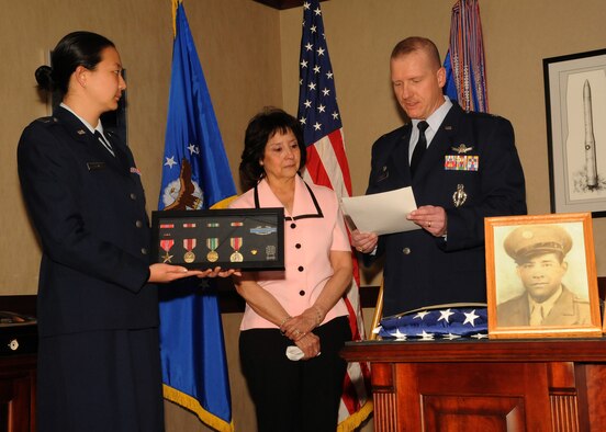 Col. Robert Stanley, 341st Missile Wing commander, reads a citation to Anna Gilmore (center), which outlines her father’s service and earned medals, as Capt. Jessica Tiffany, 341st MW executive officer, holds a display with all the medals in it during a small ceremony in Stanley’s office March 11. A photo of Anna’s father, Jose Elguezabal, sits in front of them. Most of Elguezabal’s military documents were burned in a fire in 1973, but with help from Sen. John Walsh’s office, Anna was able to receive some of her father’s medals nearly 10 years after his death. (U.S. Air Force photo/Senior Airman Cortney Paxton)