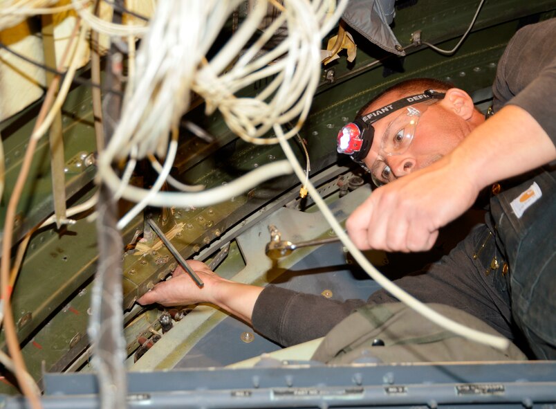 Chris Grimsley, 560th Aircraft Maintenance Squadron sheet metal worker, removes the last remaining bolts that held the C-130H nose and fuselage together. (U.S. Air Force photo/Ed Aspera)