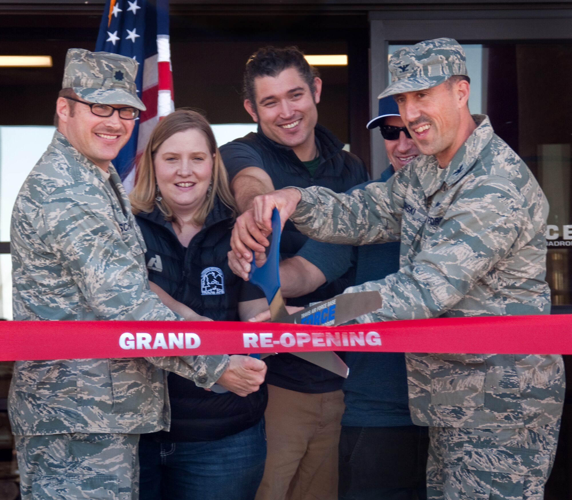 Lt. Col. Joseph Schneider, left, 60th Force Support Squadron commander, and Col. Leonard Kosinski, right, 60th Air Mobility Wing vice commander, cut the grand reopening ribbon for the newly renovated Outdoor Recreation facility March 7 ,2014, at Travis Air Force Base, Calif. (U.S. Air Force photo by Senior Airman Charles V. Rivezzo)