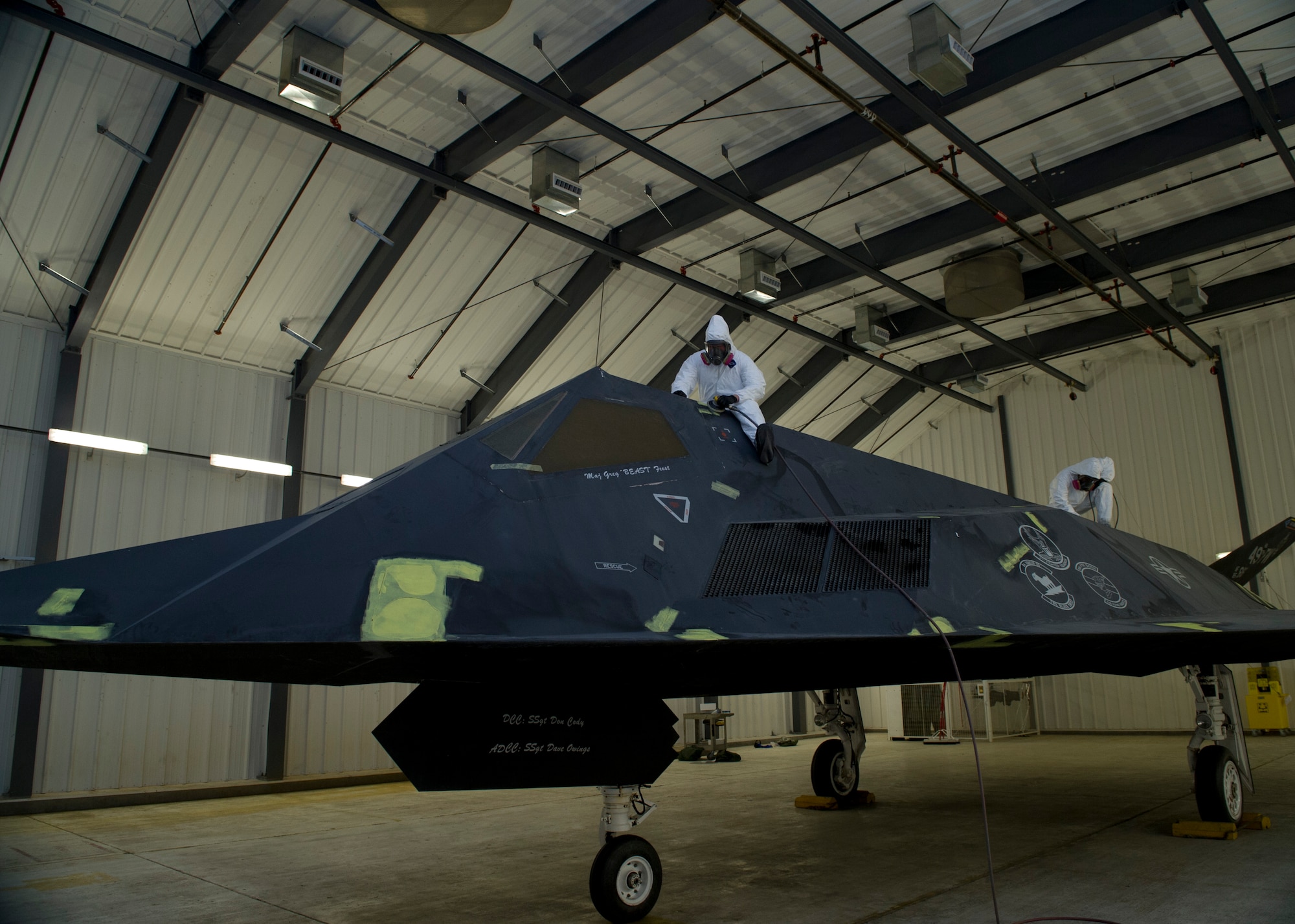 Senior Airmen Micheal Leroy  and Trevor Mendez of the 49th Maintenance Squadron, fabrication flight, perform maintenance on the F-117 Nighthawk at Holloman Air Force Base, N.M., March 13. The F-117 has been on static display in Holloman’s Heritage Park since its retirement in 2008. Due to sun and inclement weather damage, the 49 MXS removed and towed the aircraft to the hangar to begin the restoration process. Airmen will perform structural maintenance on the Nighthawk and give the aircraft a fresh paint job before returning it for display in Heritage Park. (U.S. Air Force photo by Airman 1st Class Leah Ferrante/Released)