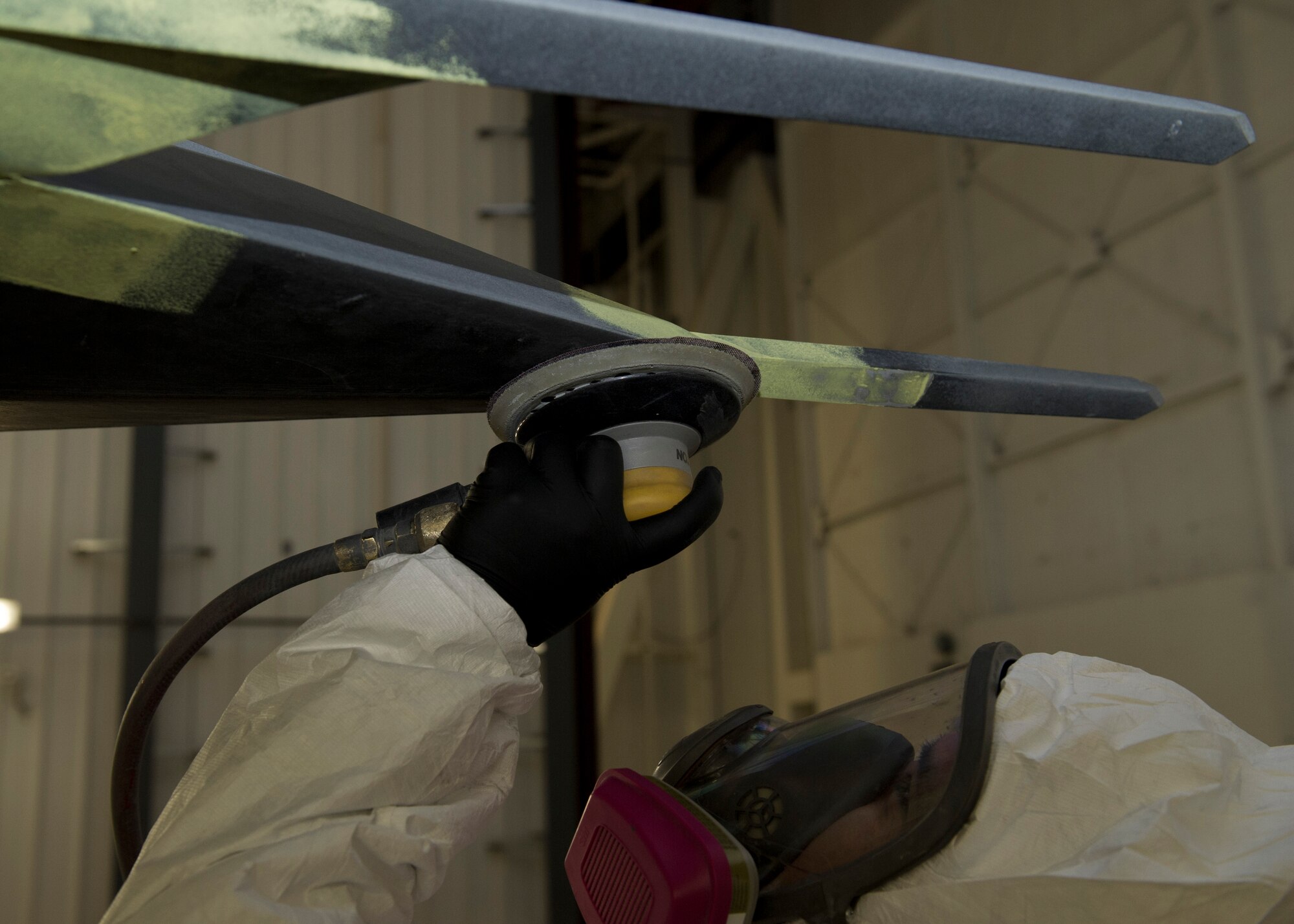 Staff Sgt. Julian Arroyo from the 49th Maintenance Squadron, fabrication flight, sands the F-117 at Holloman Air Force Base, N.M., March 13. The F-117 has been on static display in Holloman’s Heritage Park since its retirement in 2008. Due to sun and inclement weather damage the 49 MXS removed and towed the aircraft to the hangar to begin the restoration process. Airmen will perform structural maintenance on the Nighthawk and give the aircraft a fresh paint job before returning it for display in Heritage Park. (U.S. Air Force photo by Airman 1st Class Leah Ferrante/Released)