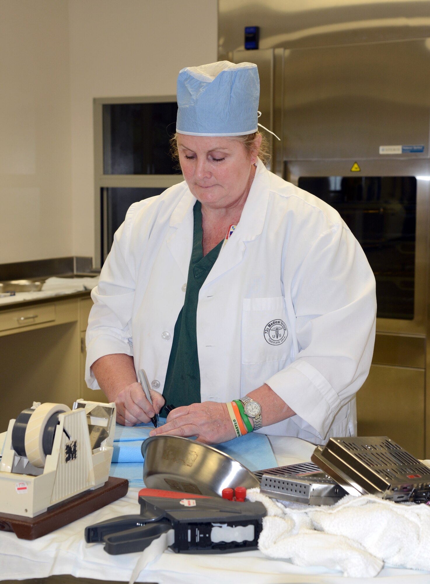 Kim Keilty, a dental assistant with the 72nd Dental Squadron, packages sterilized medical instruments and equipment in the Central Sterilization section of the 72nd Medical Group. Ms. Keilty was recognized as an outstanding performer in the 72nd Medical Group’s Accreditation Association for Ambulatory Health Care inspection last week. (Air Force photos by Kelly White)
