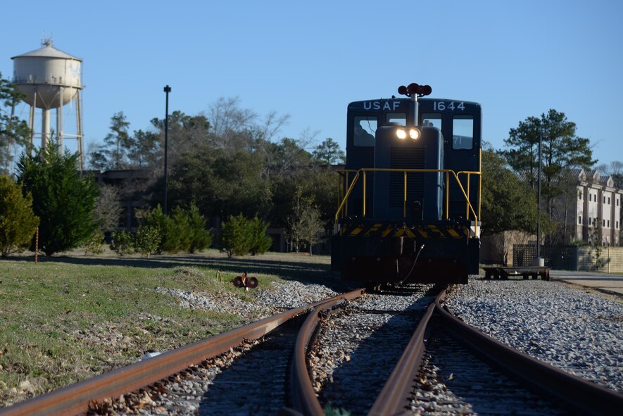 The General Electric 80-Tonner runs down the track as part of its weekly maintenance test, Shaw Air Force Base S.C., March 13, 2014. The GE-80 tonner can pull approximately 14 train cars and can reach a top speed of 45 MPH, making it a cost effective way to deliver supplies to base. (U.S. Air Force photo by Airman 1st Class Michael A. Cossaboom/Released)