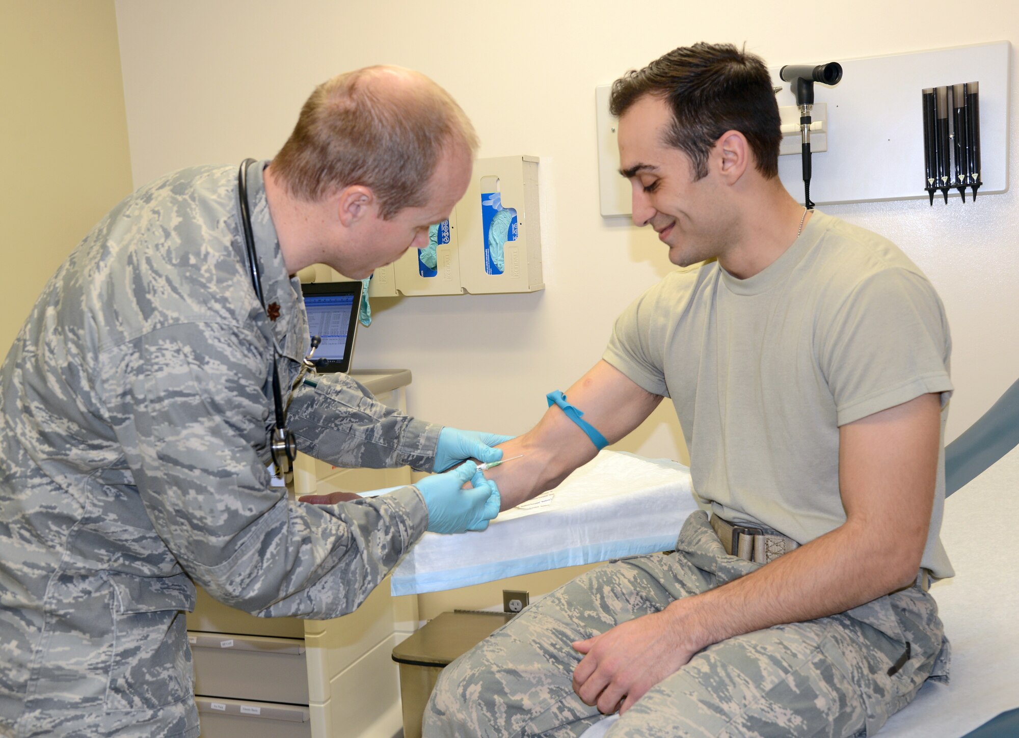 Maj. Michael Madsen and Senior Airman Joseph Hogan brush up on their shot-giving skills. Major Madsen is the Family Practice medical director and was recognized as an outstanding performer in last week’s Accreditation Association for Ambulatory Health Care inspection. (Air Force photo by Kelly White)
