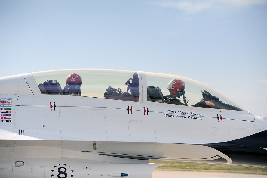 Arizona Cardinals wide reciever Larry Fitzgerald, rear, prepares for flight March 14 with U.S. Air Force Thunderbirds advance pilot/narrator Maj. Michael Fisher at the controls.Fisher has logged more than 2,000 flight hours as an Air Force pilot, with more than 430 combat hours in the F-16. Fisher is in his third season with the team and hails from Vancouver, Wash. (U.S. Air Force photo by Airman 1st Class Pedro Mota)