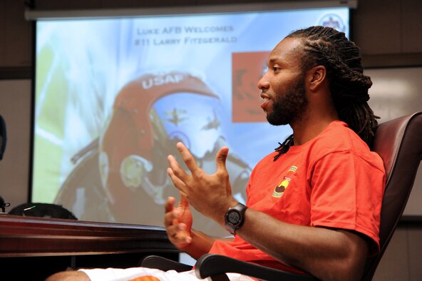 Larry Fitzgerald, Arizona Cardinals wide reciever, speaks to members of the media March 14 while waiting for his preflight briefing at Luke Air Force Base. Fitzgerald flew in U.S. Air Force Thunderbirds jet no. 8 in which he experienced all the aerial maneuvers that the Thunderbirds will be performing during Luke's Open House and Air Show on March 15 and 16. (U.S. Air Force photo by Airman 1st Class Pedro Mota)