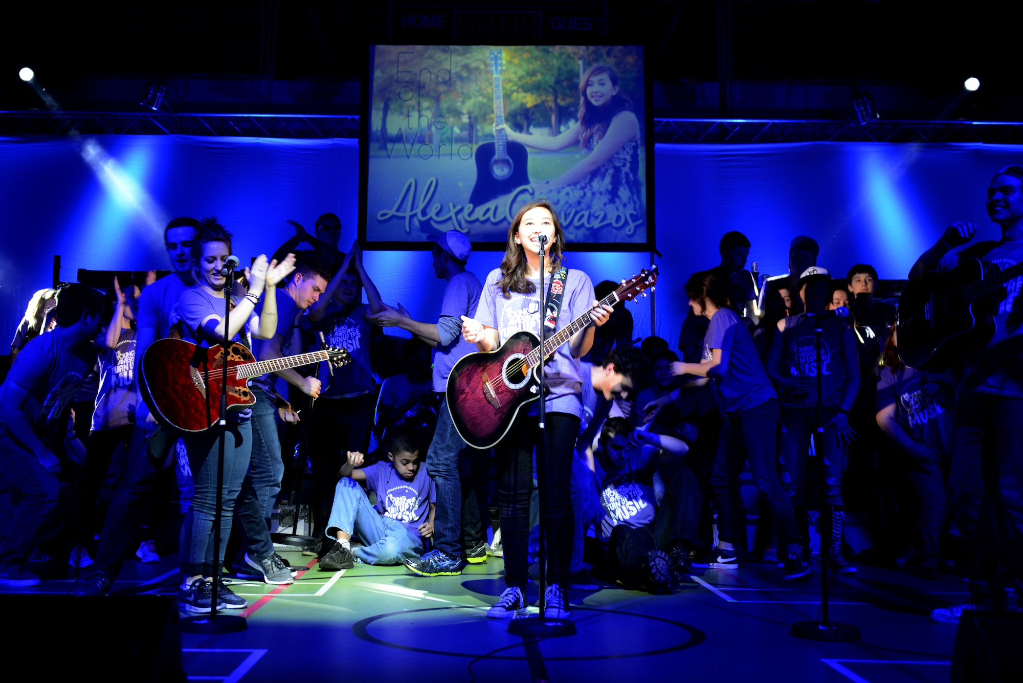 The crowd reacts as Alexea Cavazos (center), a student from RAF Alconbury Middle/High School, finishes performing a song she wrote March 1. Cavazos and more than 170 other students from RAF Alconbury participated in a two-day workshop put on by The Young Americans, culminating in the performance. (U.S. Air Force photo by Tech. Sgt. Chrissy Best)