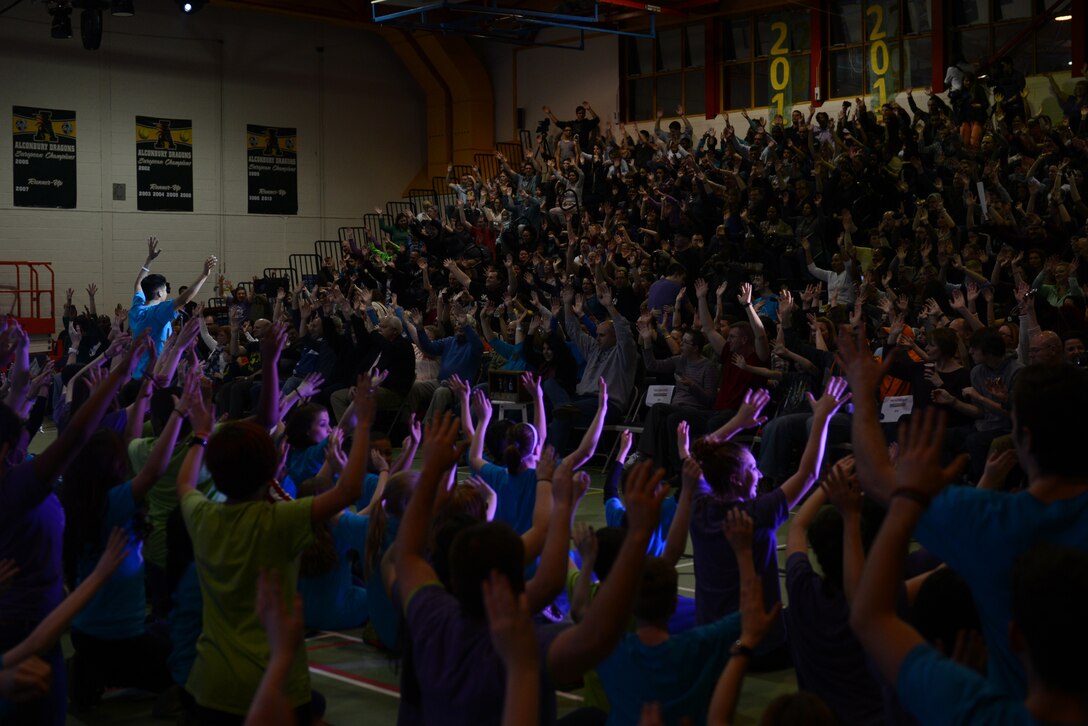 The Young Americans encourage crowd participation at the start of the second half of the performance at RAF Alconbury Middle/High School March 1. The Young Americans started in 1962 to promote music education and offer performance opportunities to young people around the world. (U.S. Air Force photo by Tech. Sgt. Chrissy Best) 