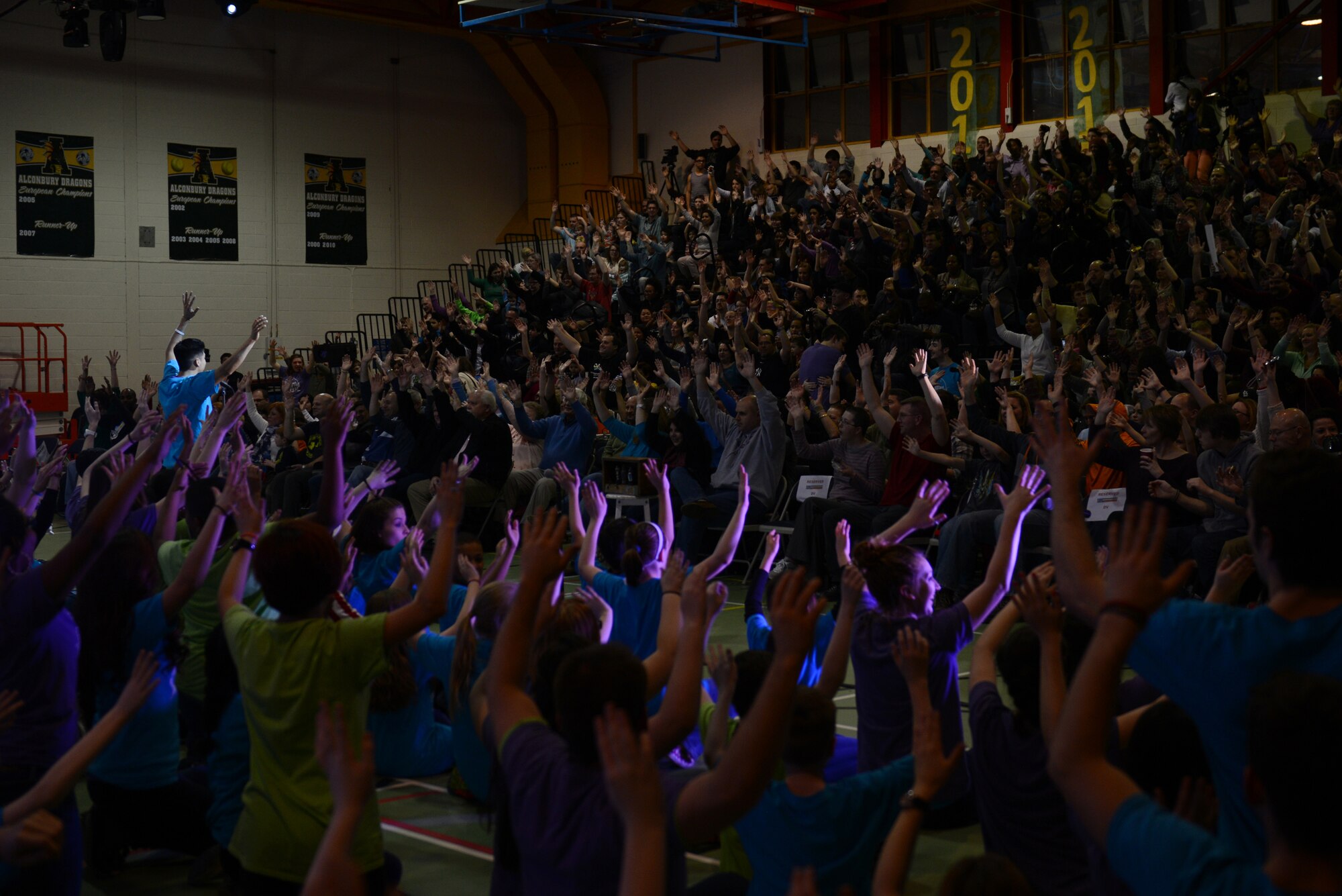 The Young Americans encourage crowd participation at the start of the second half of the performance at RAF Alconbury Middle/High School March 1. The Young Americans started in 1962 to promote music education and offer performance opportunities to young people around the world. (U.S. Air Force photo by Tech. Sgt. Chrissy Best) 