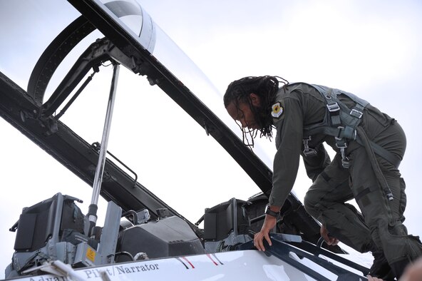 Arizona Cardinals wide reciever Larry Fitzgerald climbs into U.S. Air Force Thunderbirds jet no. 8 on March 14 at Luke Air Force Base prior to his flight in the jet. During the flight, Fitzgerald had the opportunity to experience every maneuver that will be performed during Luke's Open House and Air Show March 15 and 16 at Luke AFB, (U.S. Air Force photo by Airman 1st Class Pedro Mota)