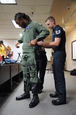 U.S. Air Force Thunderbirds crew members fit Larry Fitzgerald, Arizona Cardinals wide reciever, for a flight suit March 14. The Thunderbirds are scheduled to perform at approximately 3 p.m. on March 15 and 16 at Luke Air Force Base. (U,S, Air Force photo by Airman 1st Class Pedro Mota)