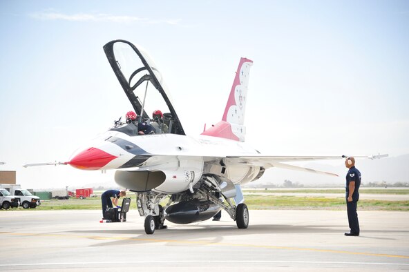 Maj. Michael Fisher, U.S. Air Force Thunderbirds advance pilot/narrator, prepares March 14 to take Larry Fitzgerald, Arizona Cardinals wide reciever, on a flight in one of the Thunderbirds' F-16 jets. The Thunderbirds are one of many aerial performers scheduled to perform March 15 and 16 during Luke's Open House and Air Show. (U.S. Air Force photo by Senior Airman Grace Lee)