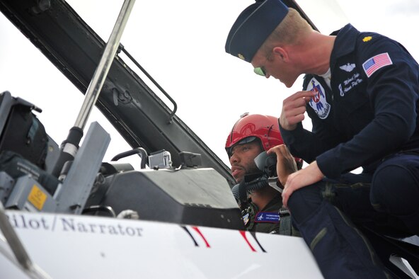 Larry Fitzgerald, Arizona Cardinals wide reciever, recieves final preflight instructions March 14 from Maj. Michael Fisher, U.S. Air Force Thunderbirds advance pilot/narrator, at Luke Air Force Base. Fisher piloted the jet that Fitzgerald flew in. (U.S. Air Force photo by Senior Airman Grace Lee)