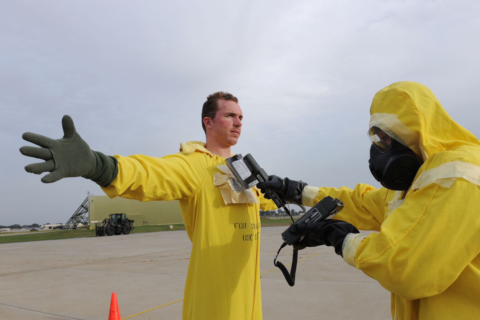 Staff Sgt. Matthew Thompson, 39th Civil Engineer Squadron explosive ordnance disposal technician, undergoes a decontamination process March 12, 2014, Incirlik Air Base, Turkey.  First responders, including security forces, fire, medical and explosive ordnance disposal Airmen, often practice scenarios for emergency situations to keep their skills sharp and procedures up to standard.   (U.S. Air Force photo by Senior Airman Nicole Sikorski/Released)