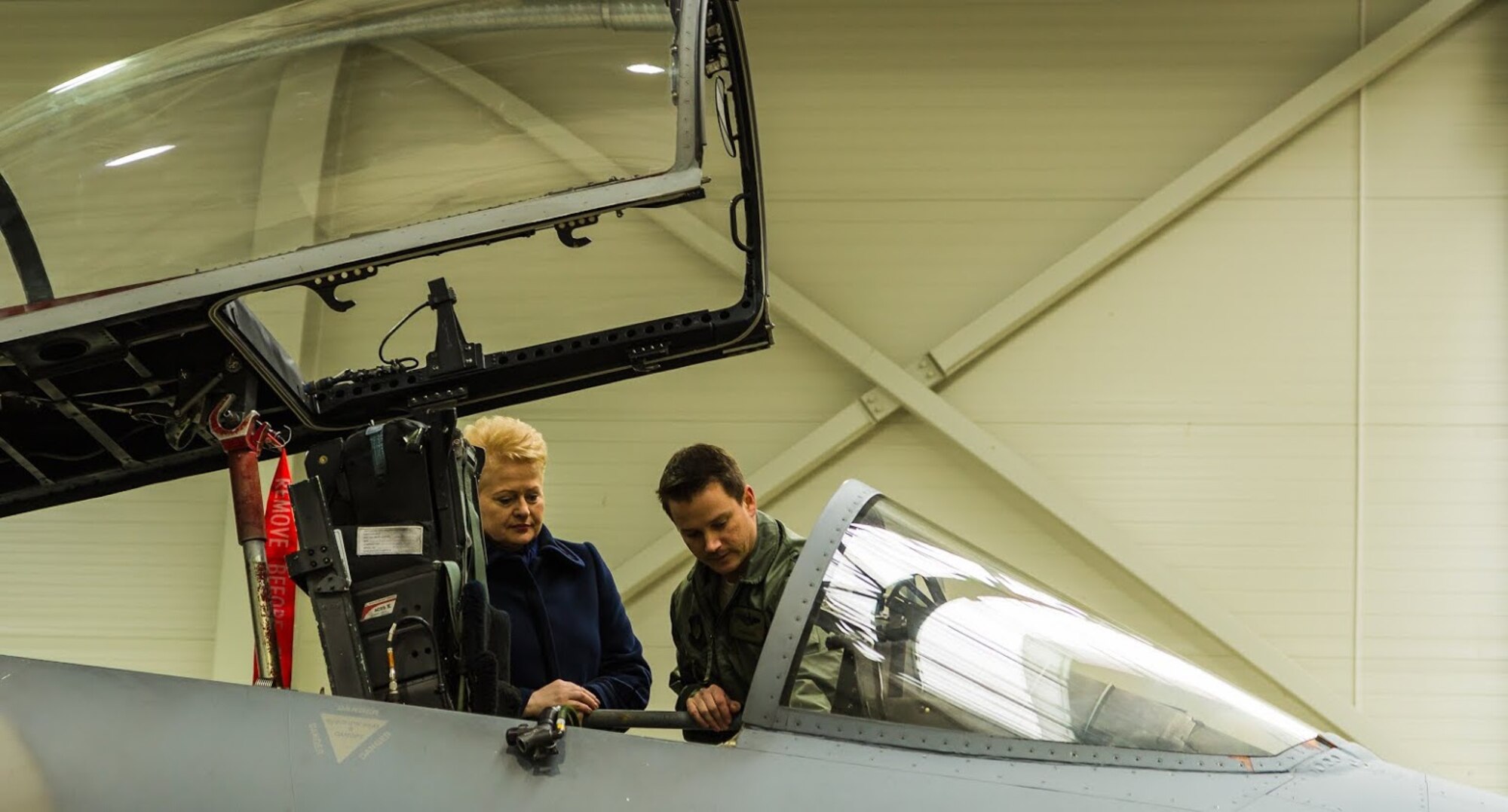 Capt. Travis Jarvi, 493rd Expeditionary Fighter Squadron pilot, shows Dalia Grybauskaitė, president of Lithuania, the cockpit of an F-15C Eagle at Šiauliai Air Base March 5, 2014. President Dalia Grybauskaitė got a closer look at the F-15C Eagles’ air superiority capabilities during her visit. The U.S. Air Force has deployed 10 jets and more than 200 personnel in support of NATO’s Baltic Air Policing mission which safeguards the air sovereignty of allies in the Baltic region. (Courtesy photo by Tech. Sgt. Nick Hodge)