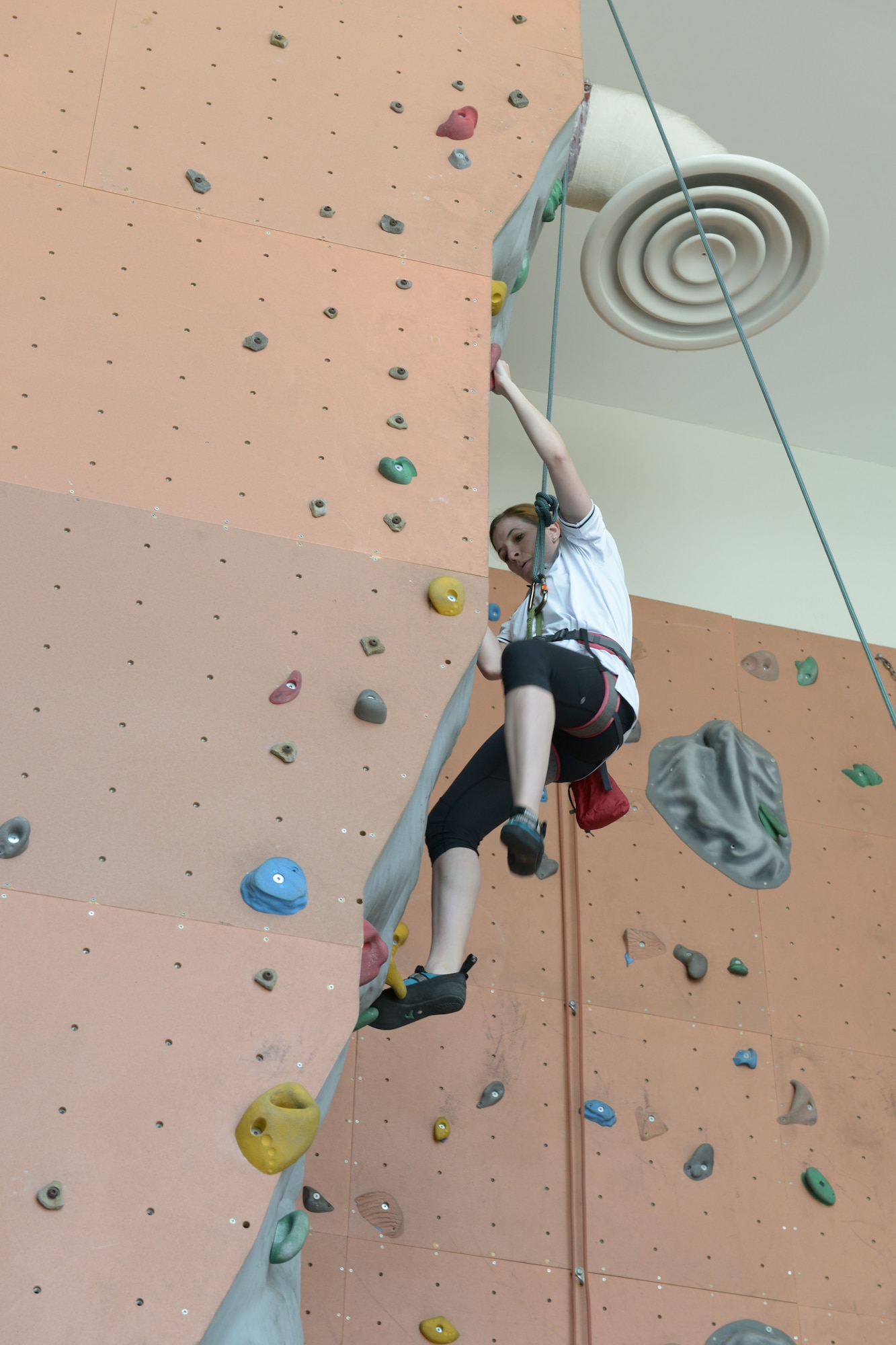 Capt. Megan Kahn climbs a rock wall during Military Appreciation Day hosted by the American School of Doha in Qatar, Mar. 7, 2014. Through the 379th Air Expeditionary Wing’s private organization Jar Saleh, Arabic for ‘Good Neighbor,’ both the 379th AEW at Al Udeid Air Base, Qatar, and the Area Support Group at Camp As Sayliyah, Qatar, have been heavily involved at ASD through a variety of volunteer opportunities. The American School of Doha showed their appreciation by hosting the 4th annual Military Appreciation Day for the Airmen, Soldiers, Sailors and Marines deployed to AUAB and CAS.  Kahn is the 379th Expeditionary Mission Support Group command sponsorship program manager and is deployed from Joint Base McGuire-Dix-Lakehurst, N.J., and hails from Keller, Texas. (U.S. Air Force photo/Senior Airman Hannah Landeros)