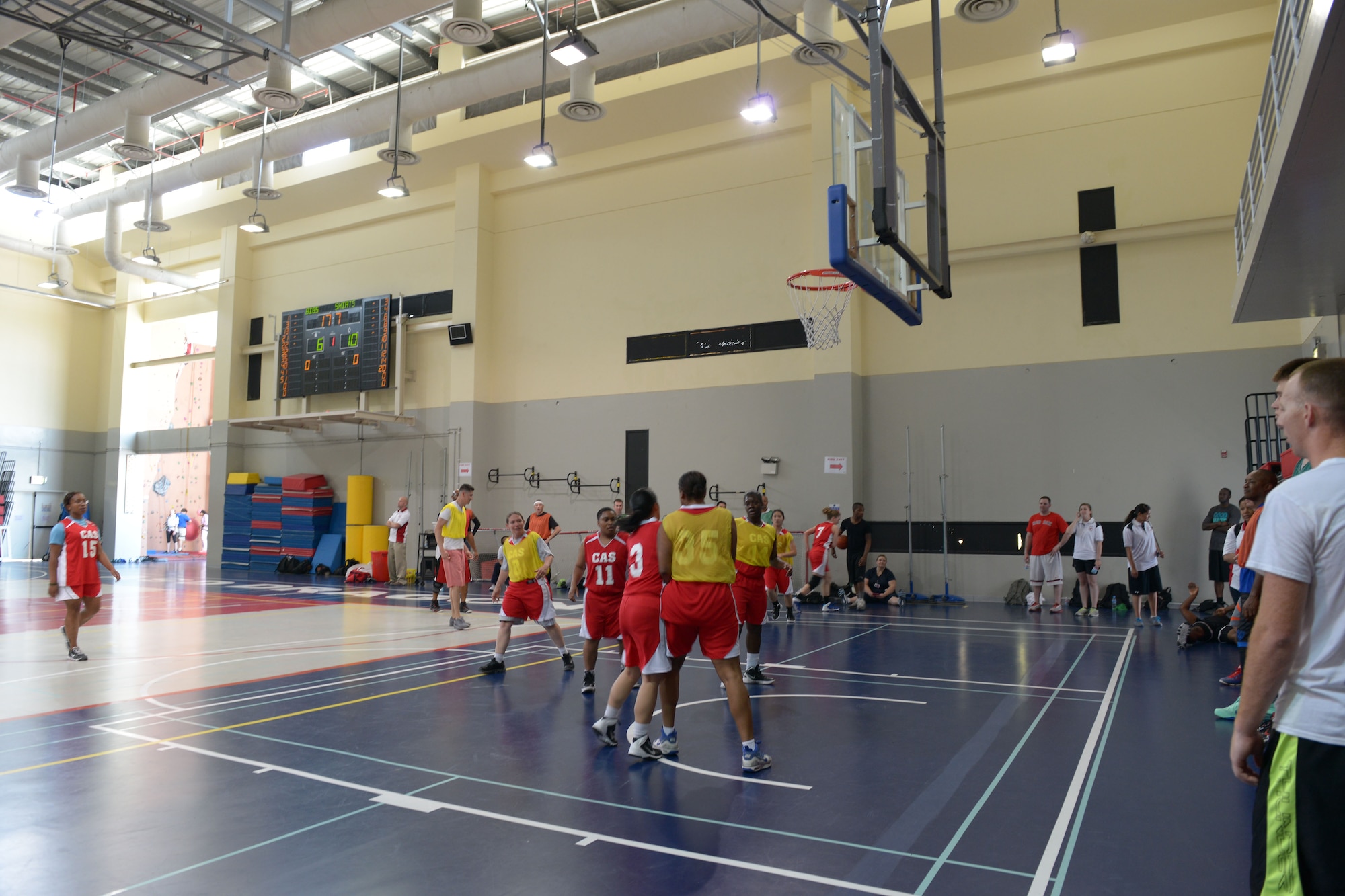 Service members participate in a basketball game with students from the American School of Doha in Qatar, during Military Appreciation Day, Mar. 7, 2014. Through the 379th Air Expeditionary Wing’s private organization Jar Saleh, Arabic for ‘Good Neighbor,’ both the 379th AEW at Al Udeid Air Base, Qatar, and the Area Support Group at Camp As Sayliyah, Qatar, have been heavily involved at ASD through a variety of volunteer opportunities.The American School of Doha showed their appreciation by hosting the 4th annual Military Appreciation Day for the Airmen, Soldiers, Sailors and Marines deployed to AUAB and CAS. (U.S. Air Force photo/Senior Airman Hannah Landeros)