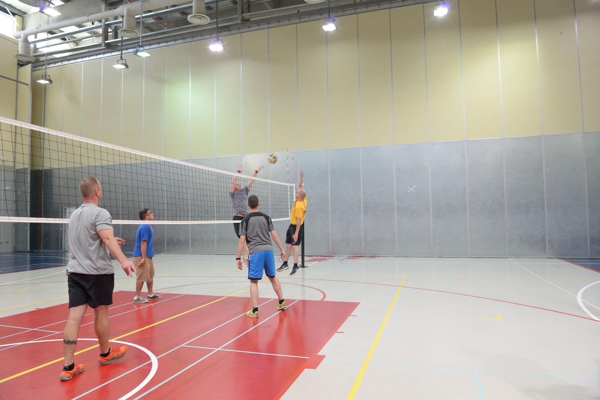 Service members participate in a volleyball game during Military Appreciation Day hosted by the American School of Doha in Qatar, Mar. 7, 2014. Through the 379th Air Expeditionary Wing’s private organization Jar Saleh, Arabic for ‘Good Neighbor,’ both the 379th AEW at Al Udeid Air Base, Qatar, and the Area Support Group at Camp As Sayliyah, Qatar, have been heavily involved at ASD through a variety of volunteer opportunities. The American School of Doha showed their appreciation by hosting the 4th annual Military Appreciation Day for the Airmen, Soldiers, Sailors and Marines deployed to AUAB and CAS. (U.S. Air Force photo/Senior Airman Hannah Landeros)
