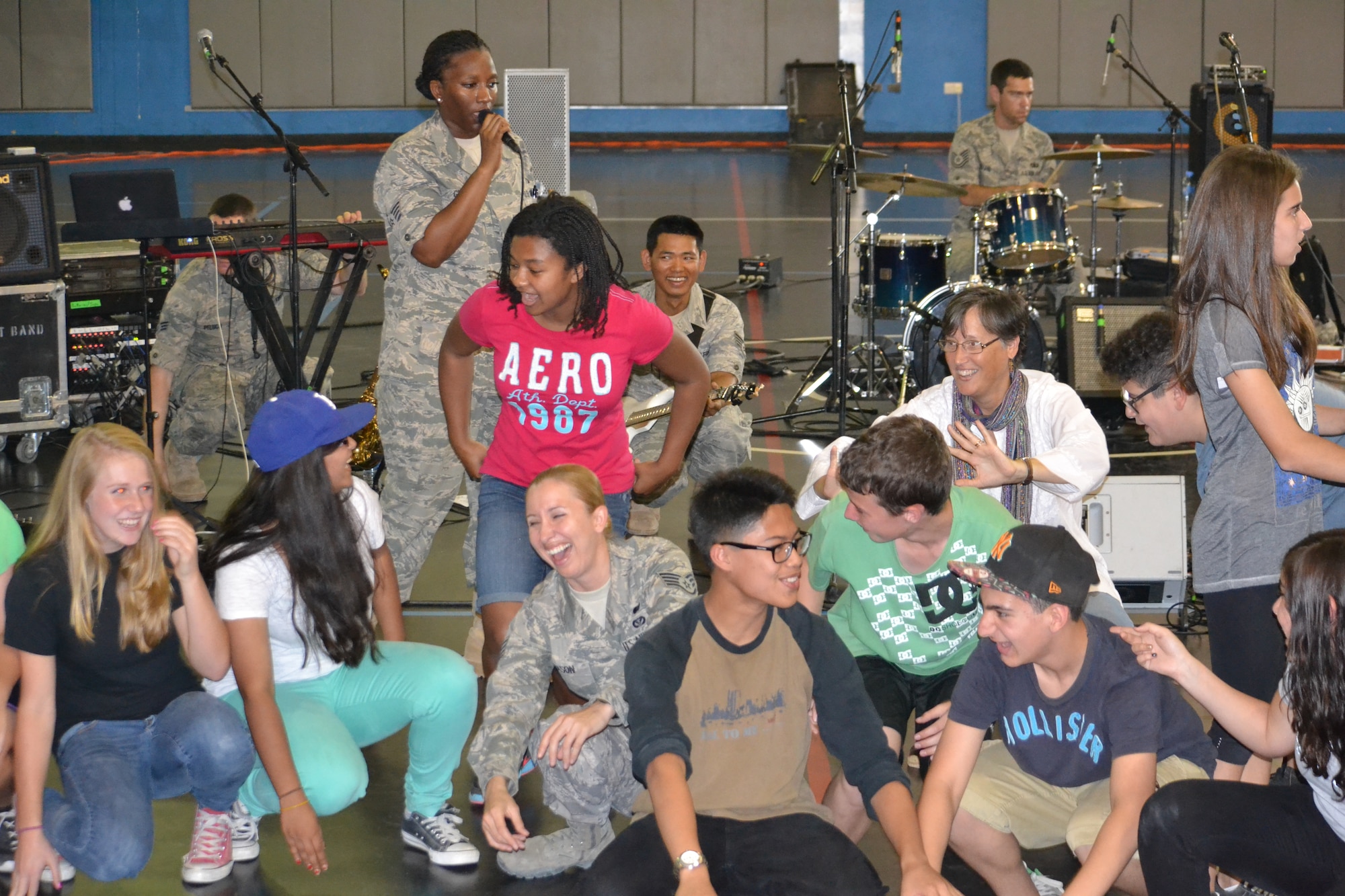 “Hypersonic,” the band assigned to U.S. Air Forces Central Command, performs for 150 8th graders from the American School of Doha at Al Udeid Air Base, Qatar, Mar. 10, 2014.  The 379th Air Expeditionary Wing hosted a field trip for ASD students, from 73 countries and showcased the variety of capabilities in the U.S. Air Force.  The AFCENT band concluded the day performing a variety of hit songs that got the Airmen and children singing and dancing. Members of “Hypersonic” are currently deployed from Yokota Air Base, Japan.  (U.S. Air Force Photo by Maj. Nicole David)