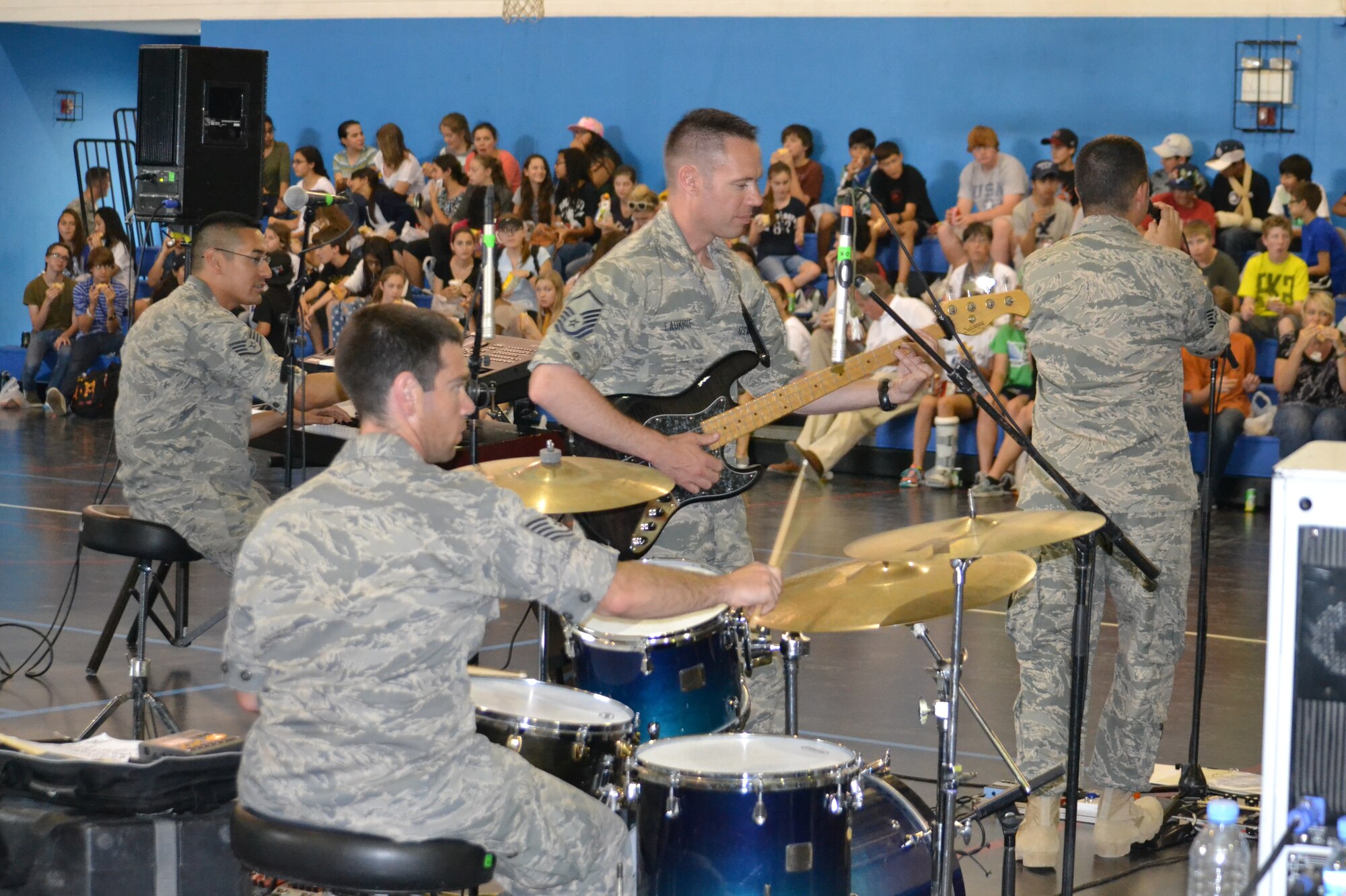 “Hypersonic,” the band assigned to U.S. Air Forces Central Command, performs for 150 8th graders from the American School of Doha at Al Udeid Air Base, Qatar, Mar. 10, 2014.  The 379th Air Expeditionary Wing hosted a field trip for ASD students, from 73 countries and showcased the variety of capabilities in the U.S. Air Force.  The AFCENT band concluded the day performing a variety of hit songs that got the Airmen and children singing and dancing.   Members of “Hypersonic” are currently deployed from Yokota Air Base, Japan.  (U.S. Air Force Photo by Maj. Nicole David)