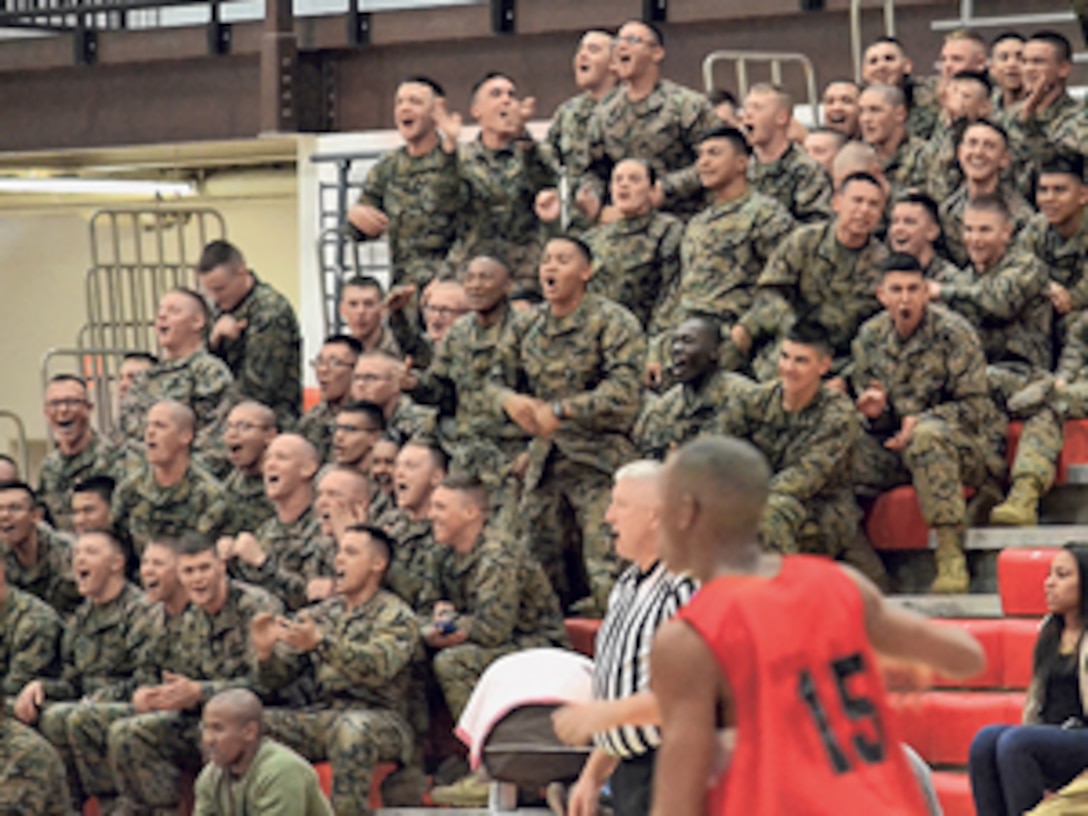 Marines cheer their team on during the second half of the Commander’s Cup Basketball Tournament March 4 at DFC. Photo by Marine Staff Sgt. C.S. Benloss