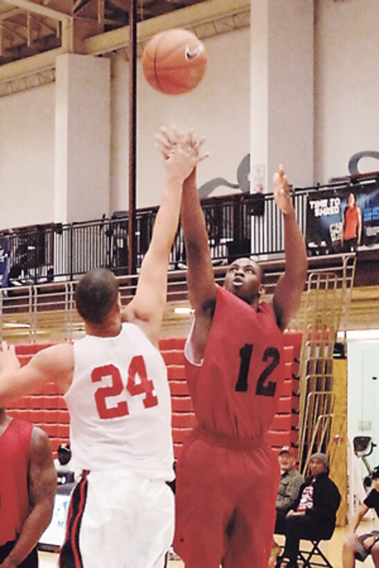 Odane Todd, 5th Engr. Bn., shoots over Marine Det. defender Marcus Jensen in the second half.