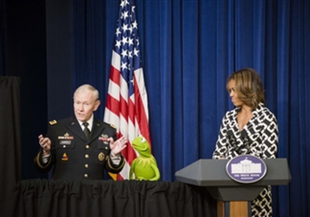 Army Gen. Martin E. Dempsey, chairman of the Joint Chiefs of Staff, talks to Kermit the Frog as First Lady Michelle Obama looks on before the screening of the new Muppets movie, "Muppets Most Wanted," for military families at the White House, March 12, 2014. Dempsey, Obama and Kermit emphasized their gratitude for the service, strength and resiliency of military families.