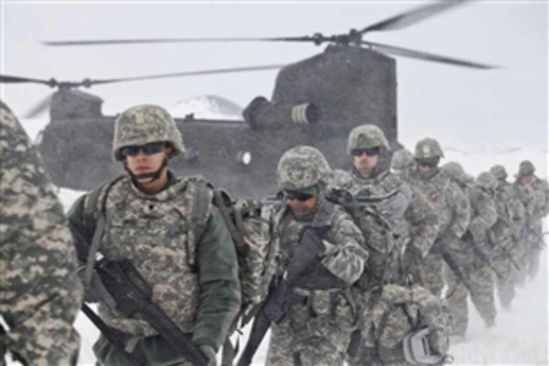 Soldiers in the 2014 Army Reserve Medical Command's Best Warrior Competition leave a drop zone to begin a four-mile ruck march in the mountainous terrain on Fort Harrison, Mont., Feb. 27, 2014. The soldiers marched in sub-zero temperatures, at times through several feet of snow. All 13 competitors wore satellite-linked safety beacons that detected if they were stationary for more than 10 minutes. 