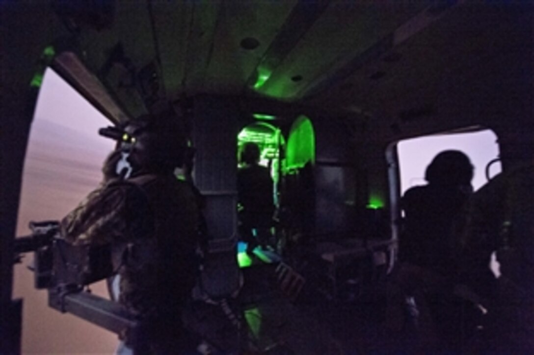 As seen through a night-vision device, U.S. and Afghan airmen fly an Mi-17 night training mission near Kabul, Afghanistan, March 13, 2014. The U.S. airmen are assigned to the 438th Air Expeditionary Wing, NATO Air Training Command Afghanistan.