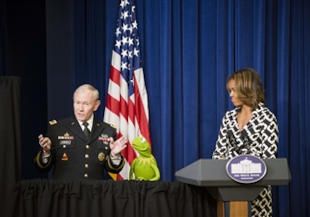 Army Gen. Martin E. Dempsey, chairman of the Joint Chiefs of Staff, talks to Kermit the Frog as First Lady Michelle Obama looks on before the screening of the new Muppets movie, "Muppets Most Wanted," for military families at the White House, March 12, 2014. Dempsey, Obama and Kermit emphasized their gratitude for the service, strength and resiliency of military families.