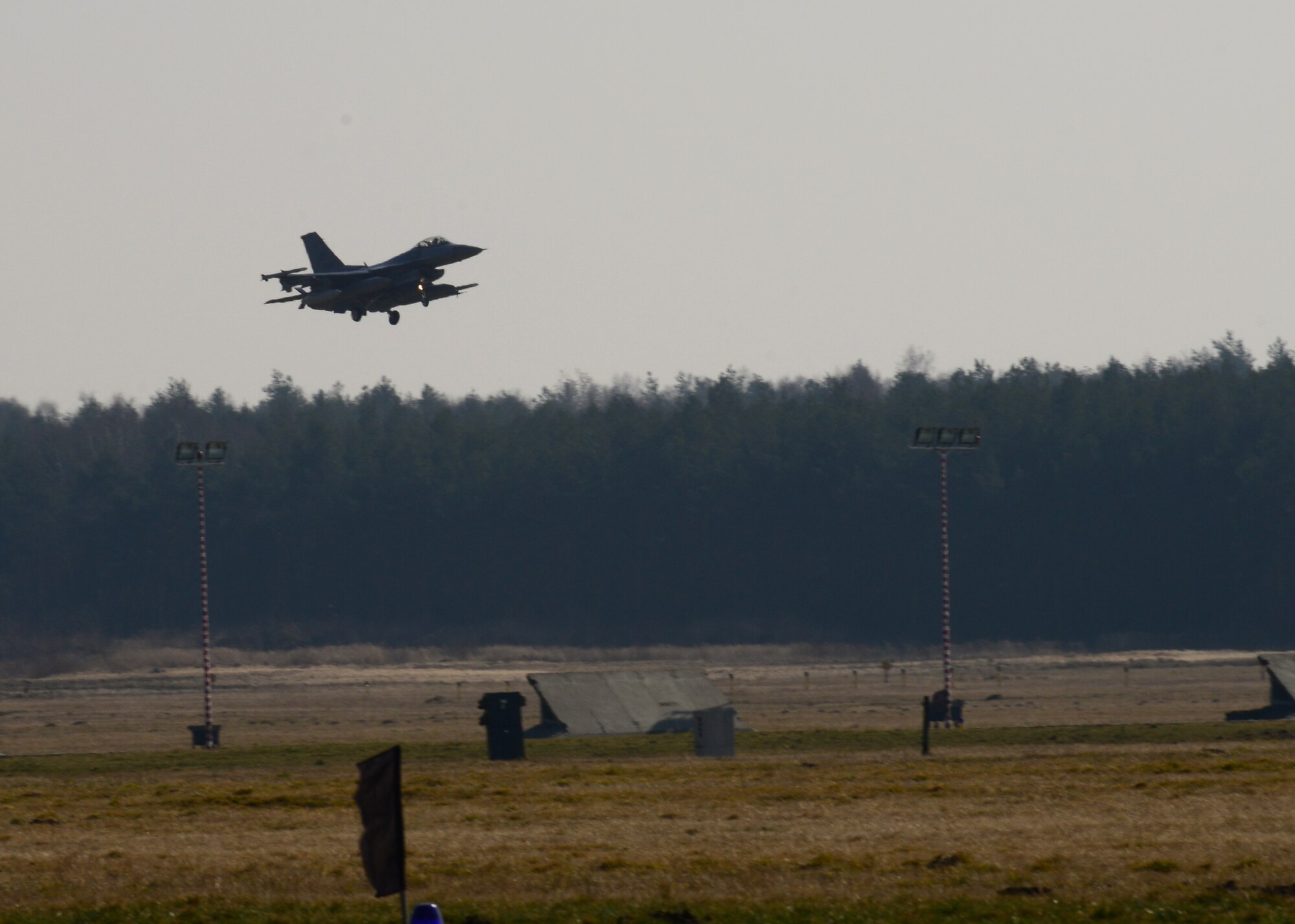 An F-16 Fighting Falcon assigned to the 555th Fighter Squadron from Aviano Air Base, Italy, lands March 14, 2014, at Lask Air Base, Poland. A total of twelve 555th Fighter Squadron F-16s and about 240 service members arrived to augment an off-site training event, which demonstrates an enduring partnership with NATO allies. (U.S. Air Force photo/Airman 1st Class Ryan Conroy) 