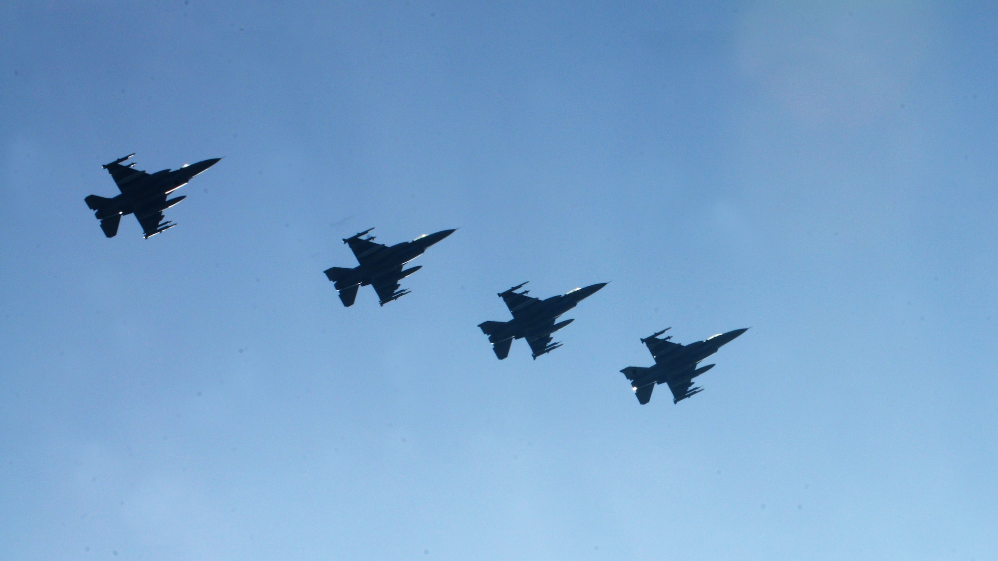 Four F-16 Fighting Falcons assigned to the 555th Fighter Squadron from Aviano Air Base, Italy, fly in formation prior to landing March 14, 2014, at Lask Air Base, Poland. A total of twelve 555th Fighter Squadron F-16s and about 240 service members arrived to augment an off-site training event, which demonstrates an enduring partnership with NATO allies.  (U.S. Air Force photo/Airman 1st Class Ryan Conroy)