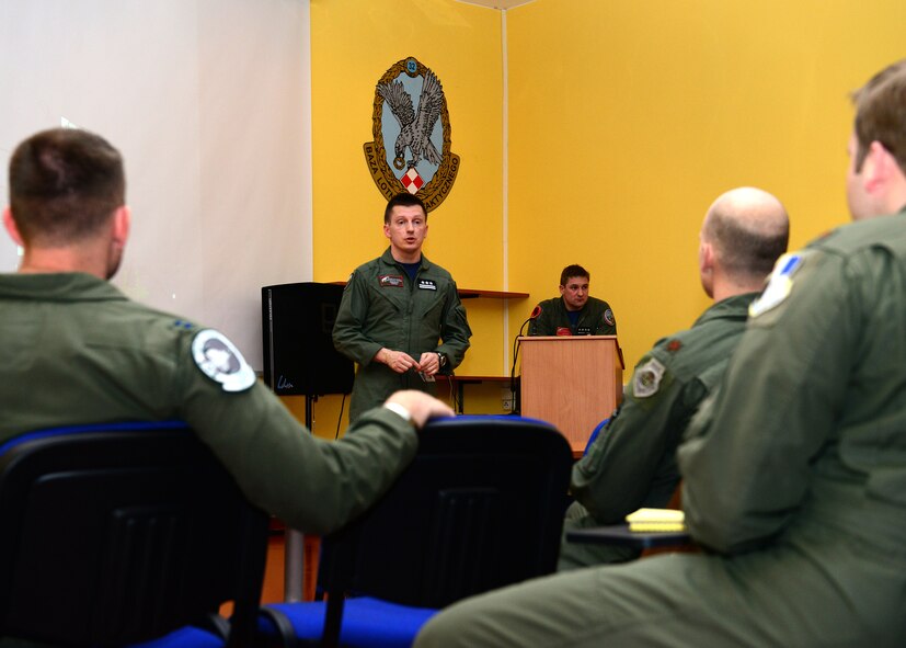 Polish air force Col. Nowak Ireneusz, 32nd Tactical Air Base Commander, greets pilots assigned to the 555th Fighter Squadron at Aviano Air Base, Italy, alongside the Polish 32nd Tactical Squadron pilots during an initial meet and greet, March 14, 2014, at Lask Air Base, Poland. NATO training fosters interoperability and enhances bilateral defense ties between the U.S. and their allies. (U.S. Air Force photo/Airman 1st Class Ryan Conroy) 