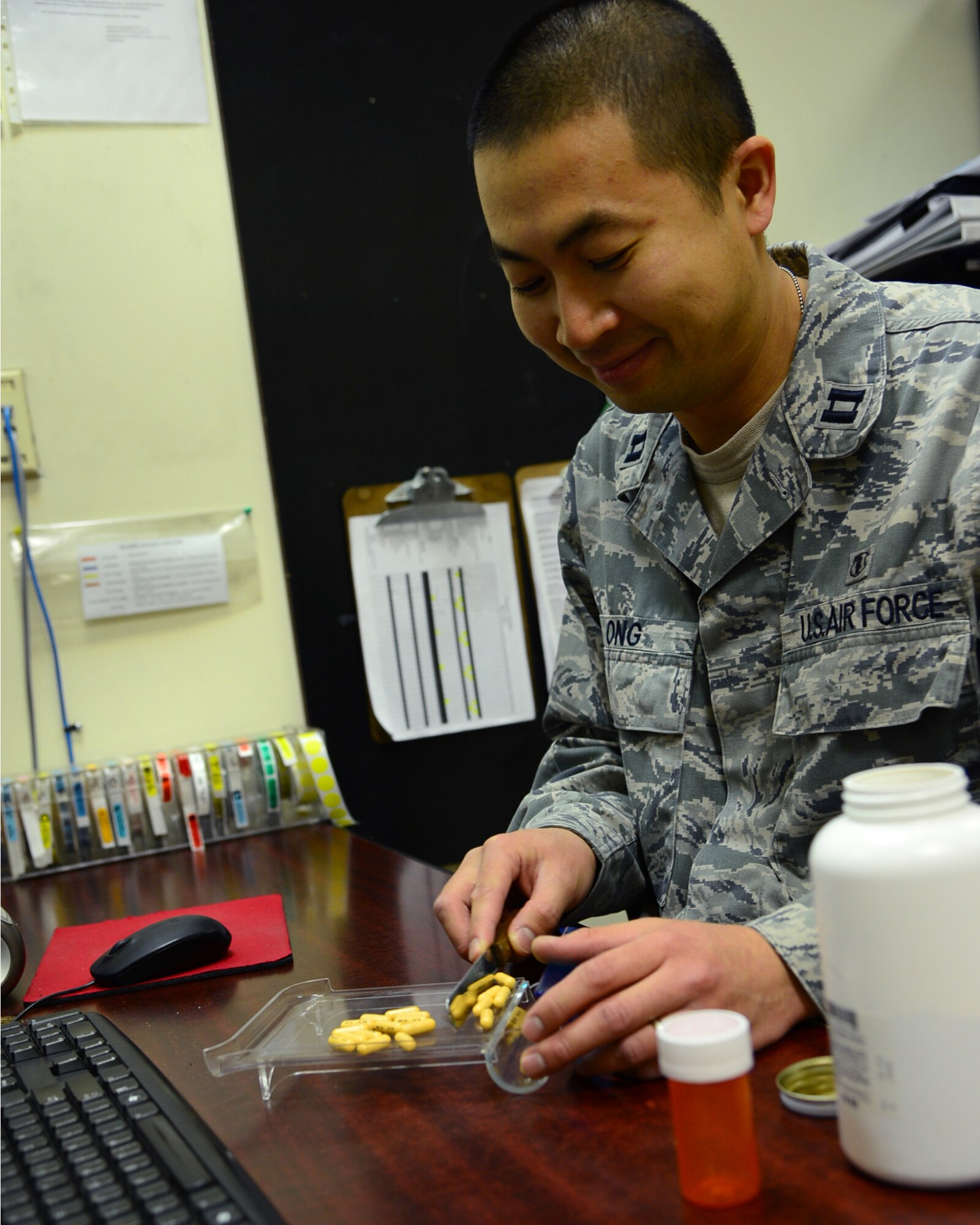 Capt. Lamont Ong, 386th Expeditionary Medical Group pharmacy officer in charge, preps prepackaged medicine at an undisclosed location in Southwest Asia. Ong is deployed from Travis Air Force Base, Calif. and a native of Los Angeles. (U.S. Air Force photo by Senior Airman Desiree W. Moye)