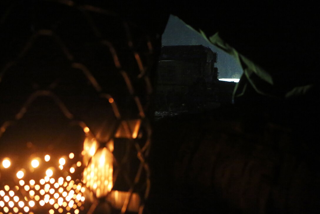 A furnace warms a tent while a Medium Tactical Vehicle Replacement belonging to 2nd Supply Battalion, Combat Logistics Regiment 25, 2nd Marine Logistics Group sits in a snowstorm during Cold Response 2014 at Elvegaardsmoen, Norway, March 14, 2014. Cold Response is a Norwegian-led multinational exercise above the Arctic Circle focused on joint operations during humanitarian assistance and war. 