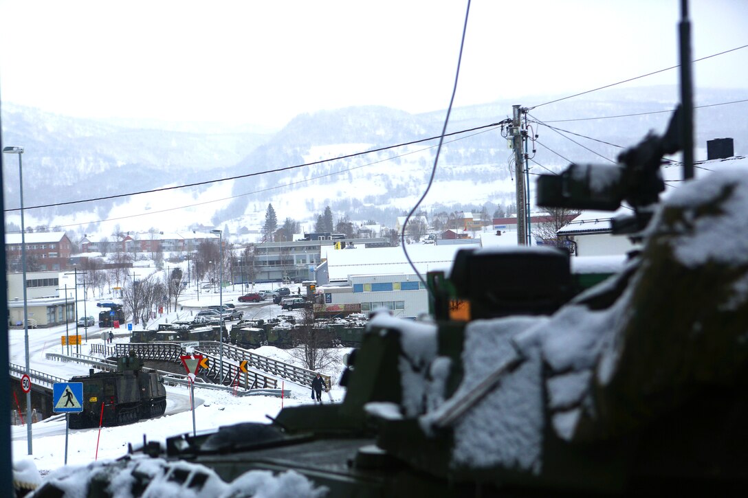 A light armored vehicle-25, the Marine Corps’ flagship eight-wheeled amphibious assault vehicle, sits above the small Norwegian town of Soreisa during Cold Response 14. Cold Response 14 brings together nearly 16,000 troops from 16 countries to train high-intensity operations in the unique climate of northern Norway, above the Arctic Circle. 


