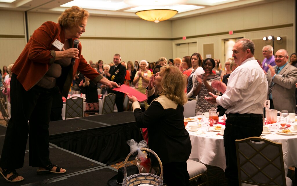 Anita Neu-Fultz, executive director, Armed Services YMCA, presents Loretta Hughes with an appreciation certificate for her efforts during the 7th Annual Heart To Heart Luncheon at the Desert Princess Golf Resort in Cathedral City, Calif., March 8, 2014. “I appreciate everyone’s hard work that went into planning this event, and look forward to many more like it honoring our military women and wives,” said Neu-Fultz. (Official Marine Corps Photo By Lance Cpl. Kasey Peacock/Released)