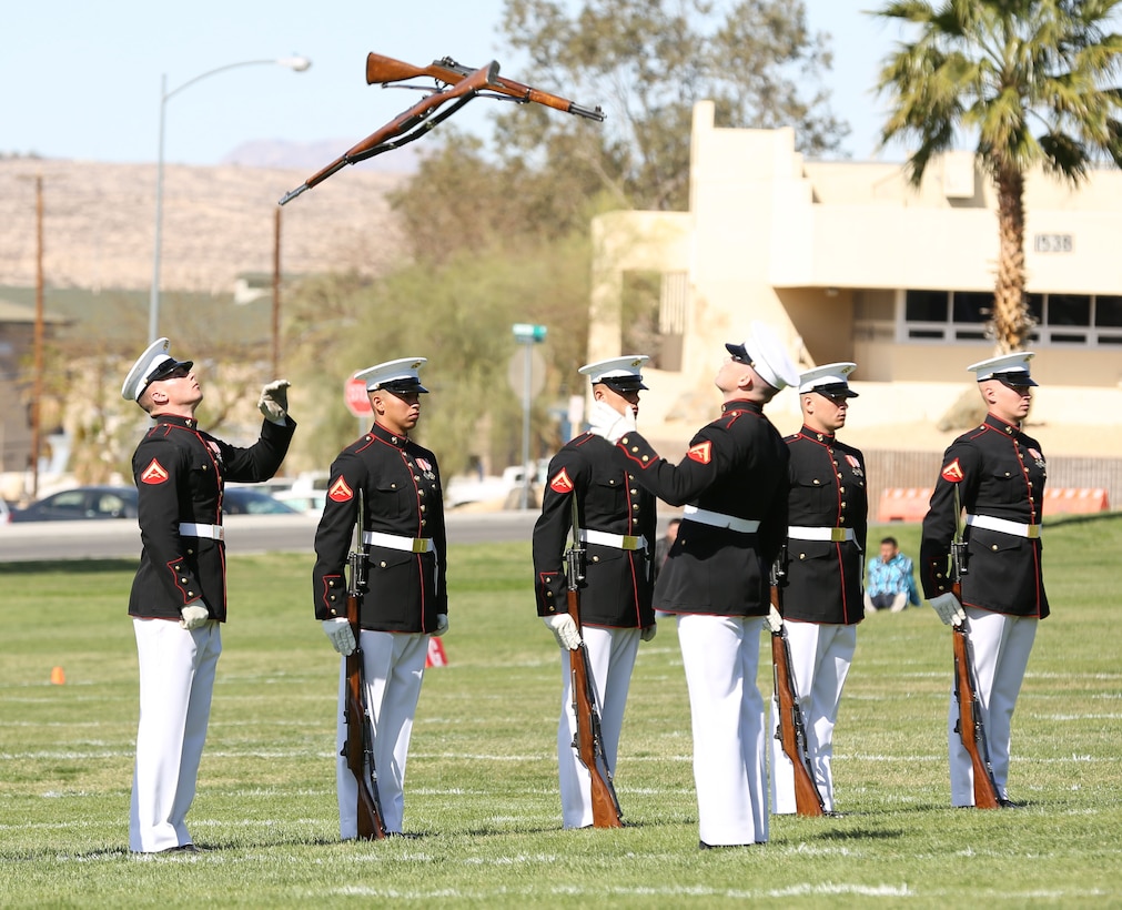 Marines with the Marine Corps Silent Drill Platoon toss their rifles to eachother during the inspection portion of their performance at the Battle Color Ceremony at Lance Cpl. Torrey L. Gray Field, March 12, 2014. The platoon conducts all of their movements with no verbal commands. (Official Marine Corps photo by Cpl. Alejandro Bedoya/ Released)