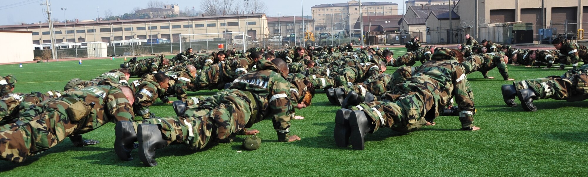OSAN AIR BASE, Republic of Korea - Members of the 7th Air Force perform the Medal of Honor Push-Ups as the last exercise of the day during PT March 14, 2014. At the end of each monthly PT session, 7th AF members call out the names of and perform a push-up for each of the 10 7th AF members throughout history who have received the Medal of Honor. (U.S. Air Force photo by Maj. Richelle Dowdell)