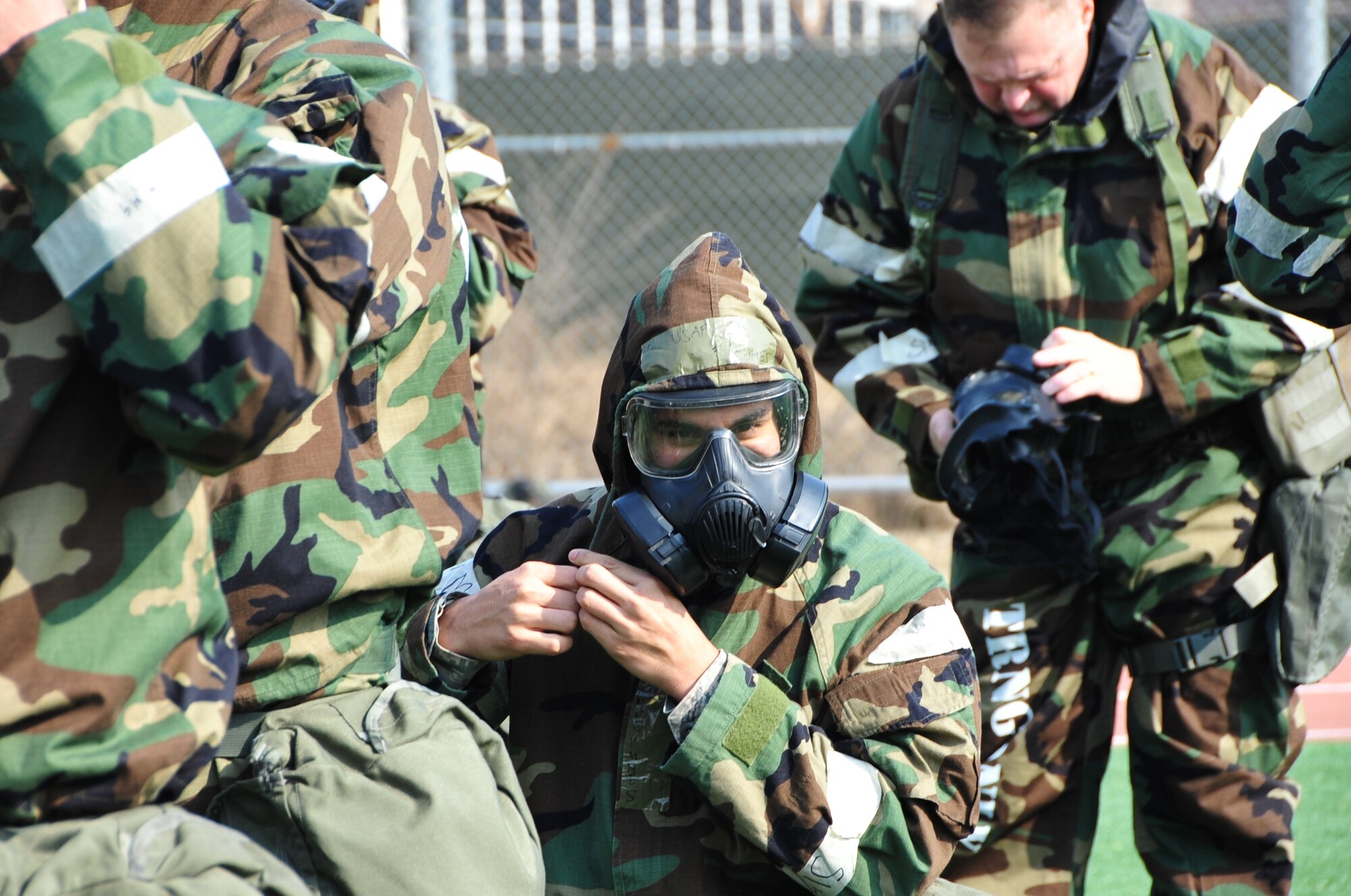 OSAN AIR BASE, Republic of Korea - Members of the 7th Air Force staff don their MOPP gear for PT March 14, 2014. Staff members had to wear their gas mask, overgarment, gloves and protective boots during a circuit of exercises that included th low crawl, rush 'n roll, perform buddy carries, do push-ups, crunches and side-straddle hops. (U.S. Air Force photo by Maj. Richelle Dowdell)