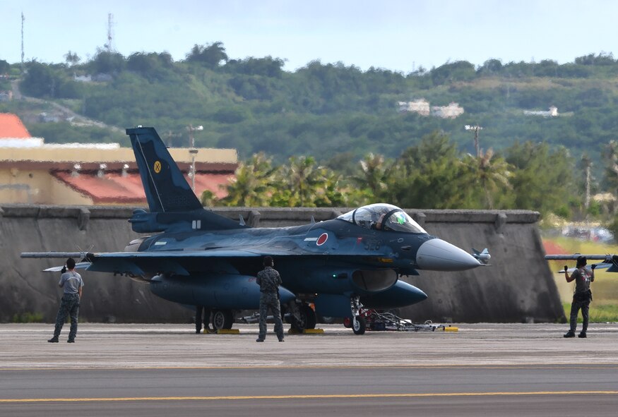 Japan Air Self-Defense Force Airmen prepare a Mitsubishi F-2 aircraft for takeoff during Exercise Cope North 2014 on Andersen Air Force Base, Guam Feb. 21, 2014. Cope North is an annual event that focuses on air combat tactics and large force employment in an effort to enhance interoperability among U.S., Japan, Australian and Korean forces. (U.S. Air Force photo by Senior Airman Katrina M. Brisbin/Released)