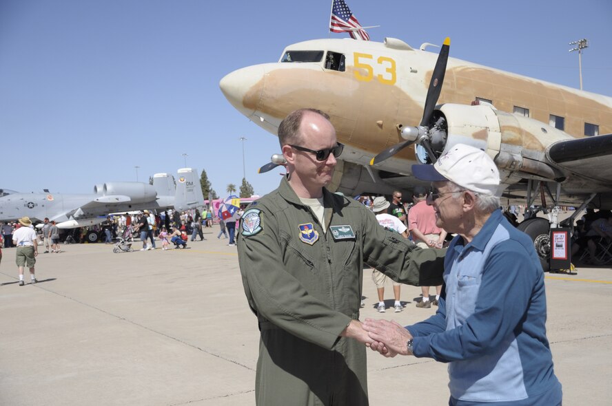 Lt. Col. Chris Bacon, 308th Fighter Squadron commander, coins 1st Lt. Ken Sadick, a World War II veteran, March 15 at Luke Air Force Base's Open House and Air Show. Sadick, 90 years old, graduated from Luke Field in March 1944, receiving his wings exactly 70 years ago this month. (U.S. Air Force photo by Staff Sgt. Timothy Boyer) 
